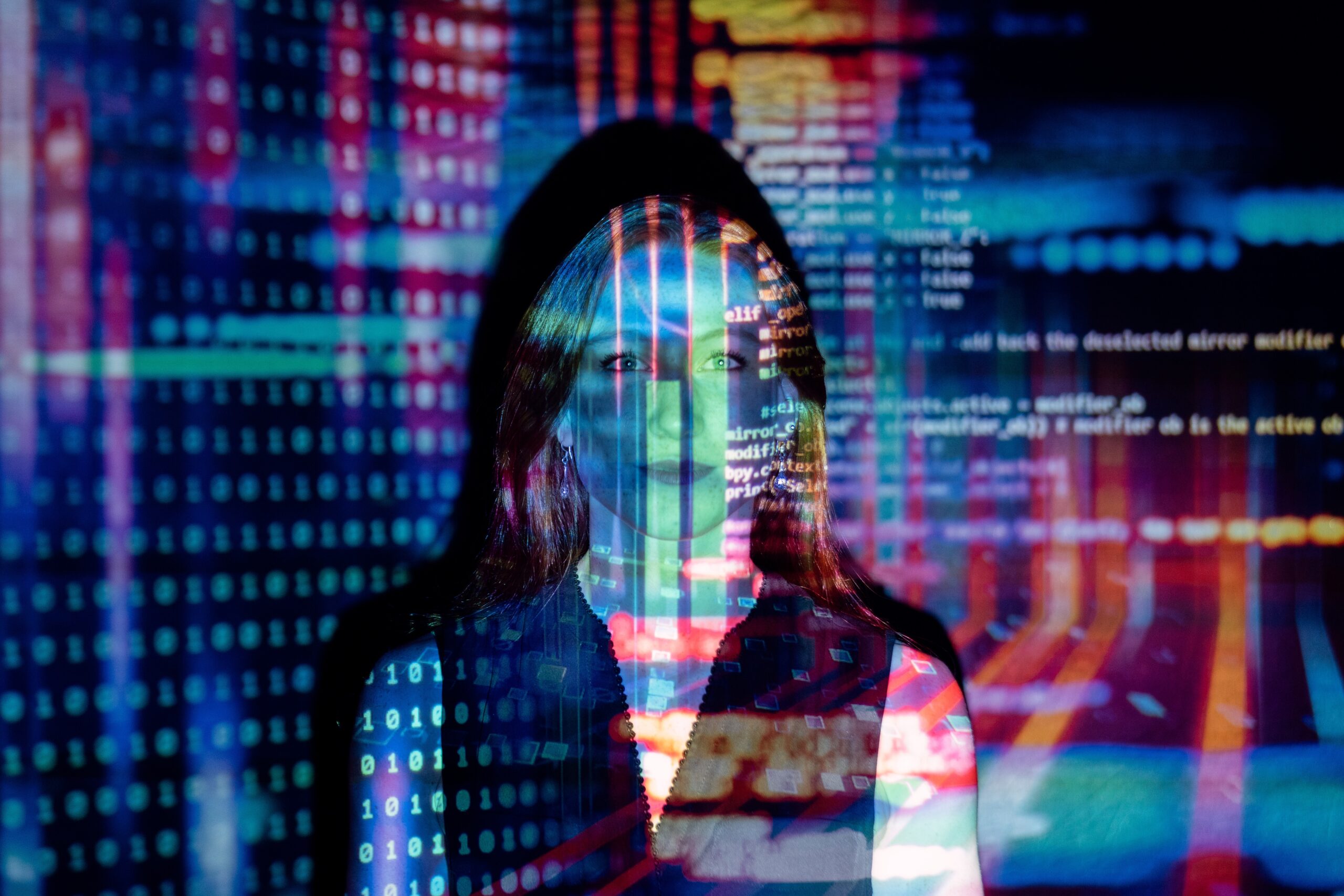 woman with neon lights and numbers of a computer screen projected onto her face