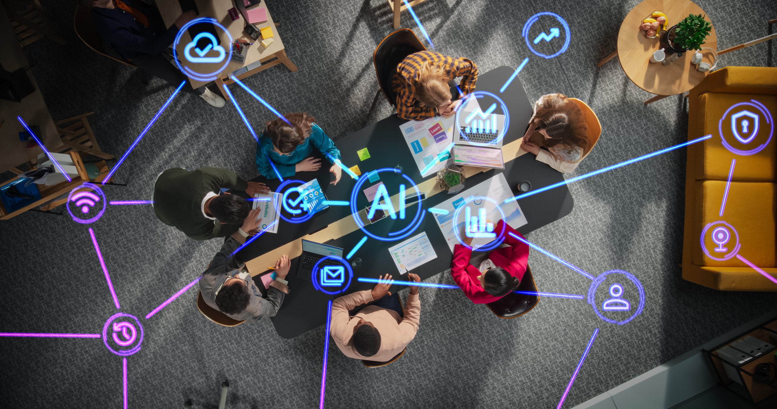 Diverse Team Collaborating with AI Tools in a Modern Office Meeting Room. Top Down View Highlighting Dynamic Interaction and Advanced Technology Integration with Holographic Interfaces A group of people at a conference table having a meeting, using advanced digital tools, with neon blue holographic AI icons floating above them